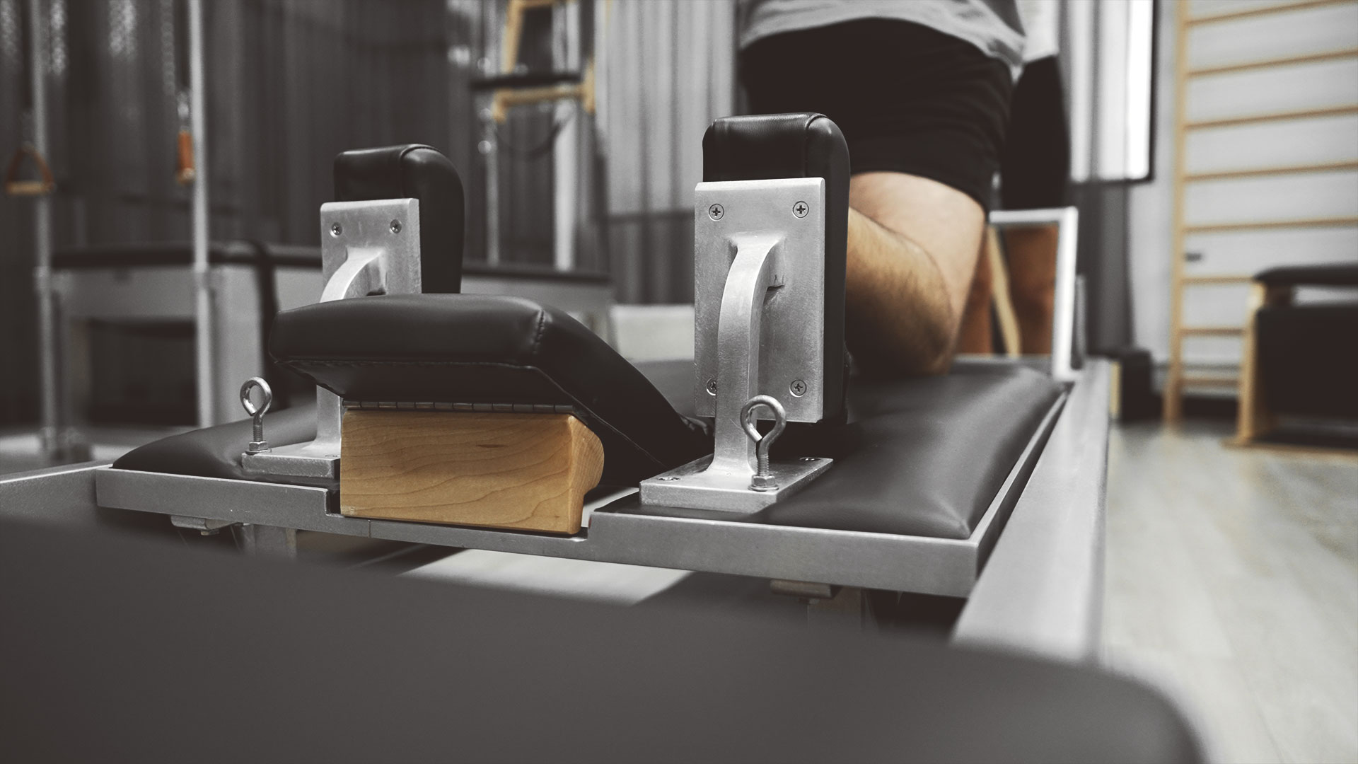 Close-up of a Classical Pilates reformer footbar and carriage at a Power Pilates studio in Manhattan